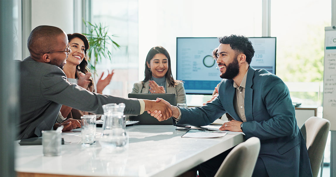 Businessmen shaking hands and smiling